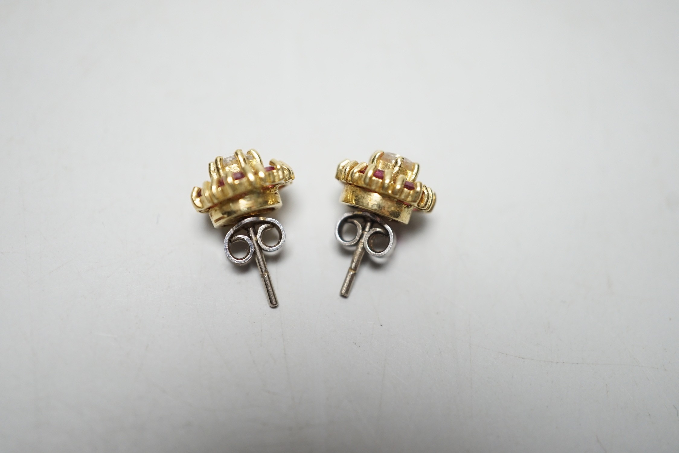 A pair of 18ct gold, diamond and garnet? circular cluster ear studs, 9mm, gross weight 4 grams.